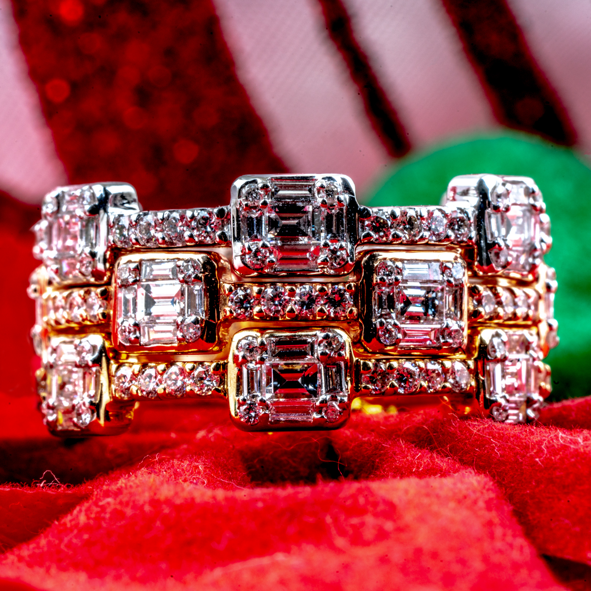 Yellow, rose, and white gold interlocking rings set with diamonds.