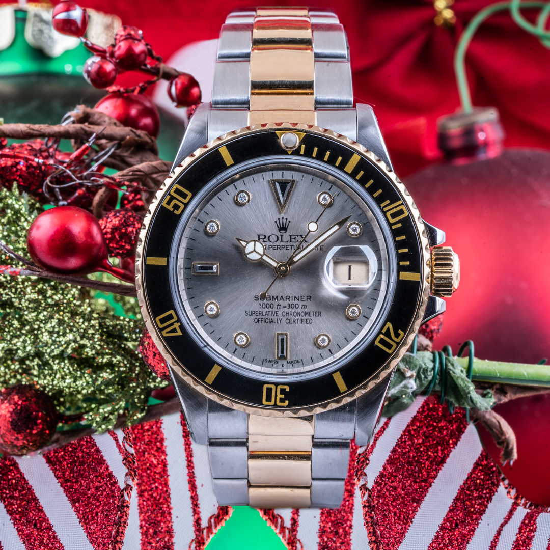 Pre-owned men's Rolex Submariner in stainless steel and yellow gold with a gray dial and black ceramic bezel.