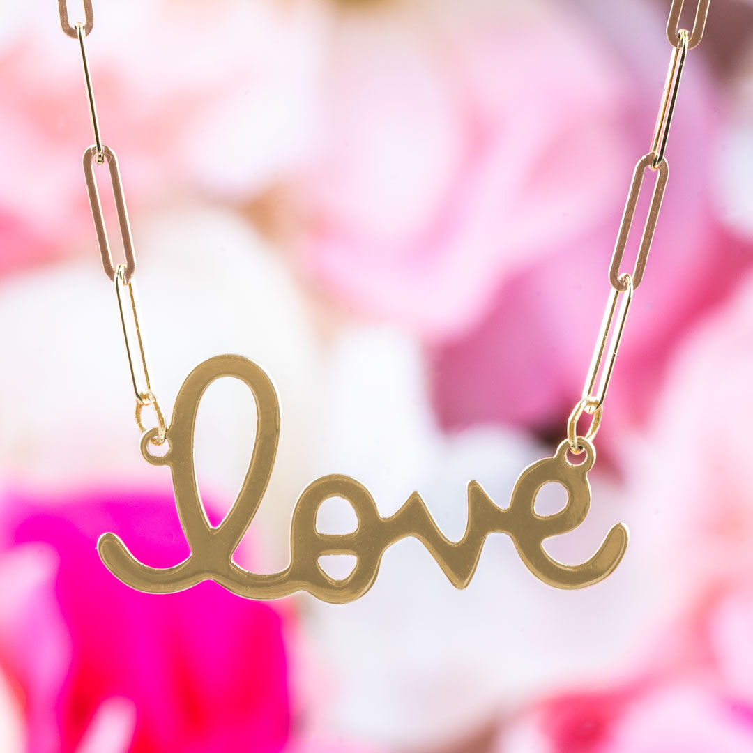 Yellow gold station necklace with "LOVE" script.